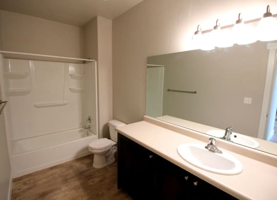 a bathroom with a white toilet next to a white sink
