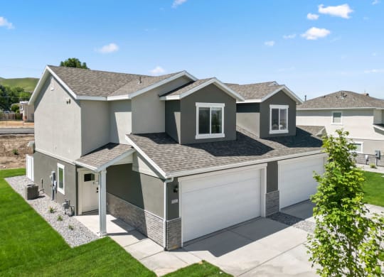 a home with a gray exterior and a gray roof