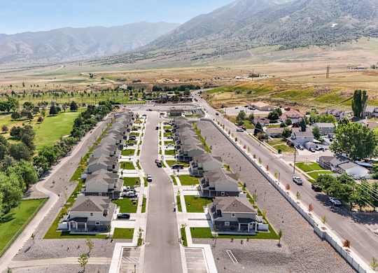 A suburban neighborhood with houses and a mountain range in the background.