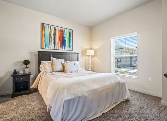 a bedroom with a large bed and a window
