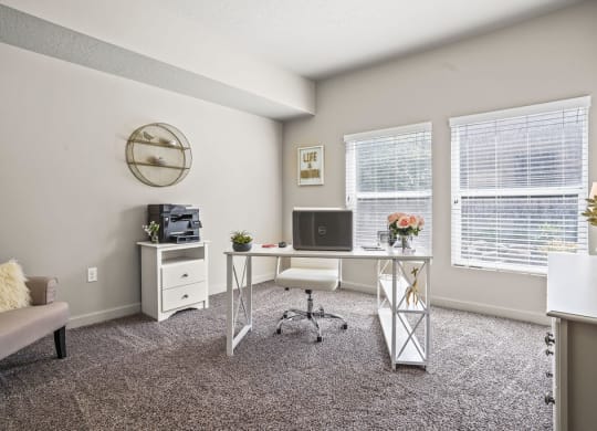 our apartments have an office with a desk and chair and a window