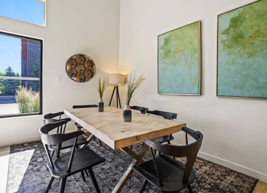 a dining room with a wooden table and chairs
