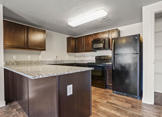 a kitchen with a counter top and a refrigerator