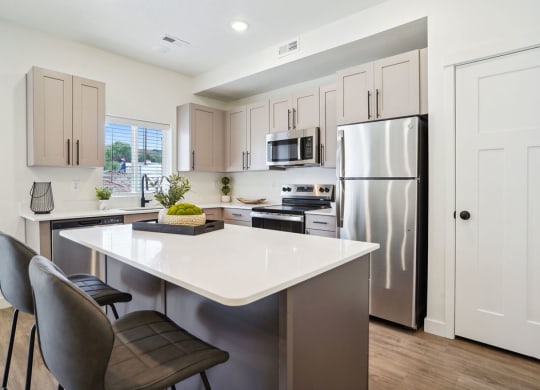 a kitchen with stainless steel appliances and a white counter top