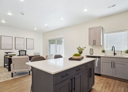 an open kitchen and living room with a table and chairs