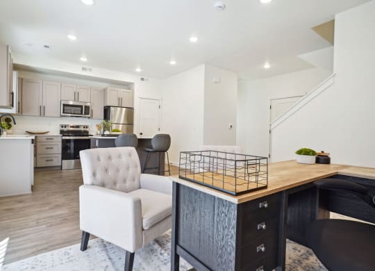 an open kitchen and living room with a counter top and a table