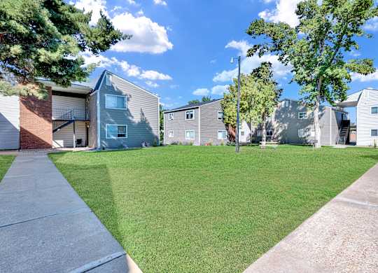 A sunny day at a residential area with houses and green lawns.