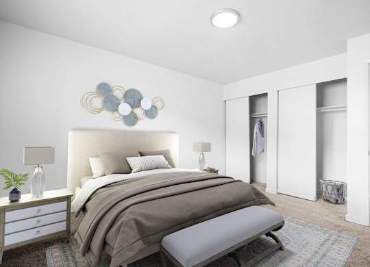 A bedroom with a large bed and a bench in front of it.