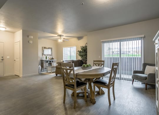 an open living room and dining room with a table and chairs