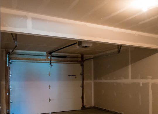 a garage with a white wall and a garage door