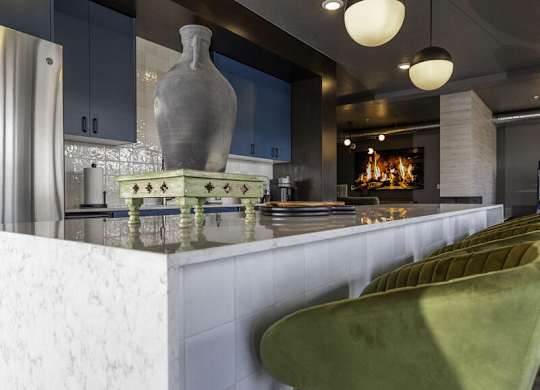 a kitchen with a marble counter top and a fireplace