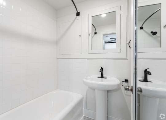 a bathroom with a sink and a tub and a mirror