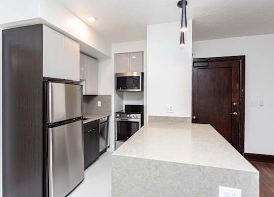 a kitchen with stainless steel appliances and a large island