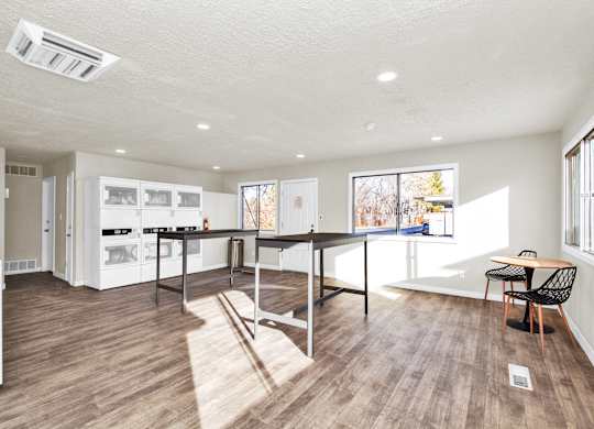 A kitchen with a table and chairs in the middle of the room.