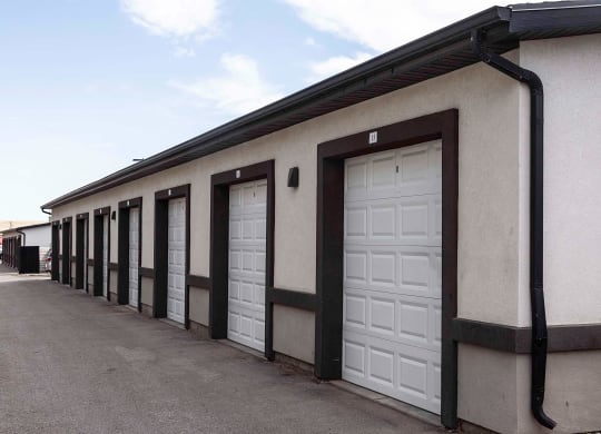 a row of garage doors in front of a building