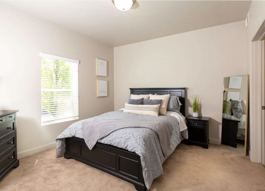 a bedroom with a large bed and two night stands