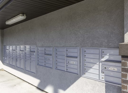 a picture of the side of a building with a bunch of mailboxes