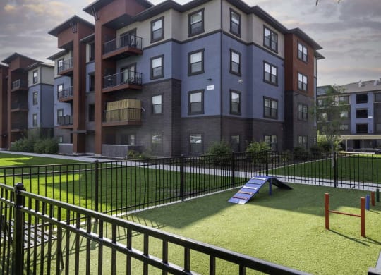 a rendering of an apartment building with a playground in the foreground