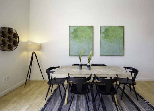 a dining room with two paintings on the wall