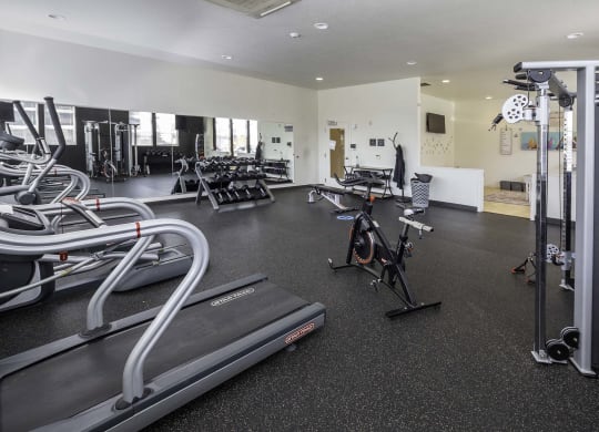 a room filled with lots of different types of exercise equipment