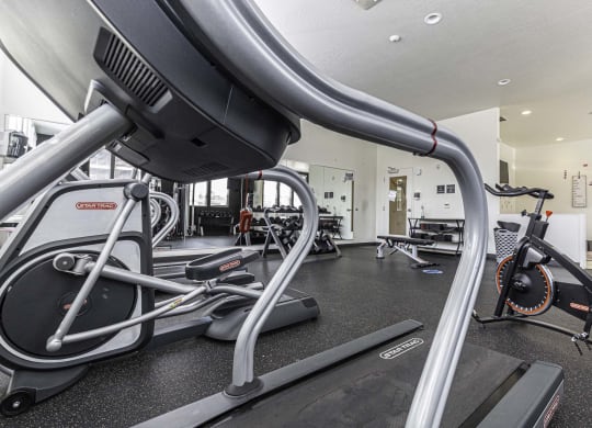 a room filled with lots of different types of exercise equipment