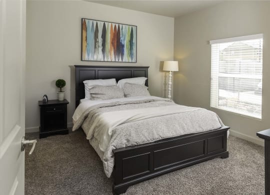 a bedroom with a large bed and two nightstands