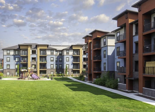 an exterior view of an apartment complex with a playground