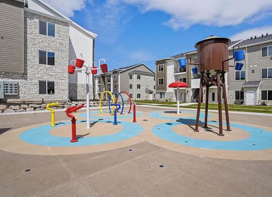A playground with a water tower and a slide.