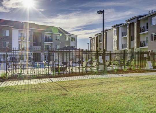A sunny day at a residential area with apartment buildings and a playground.