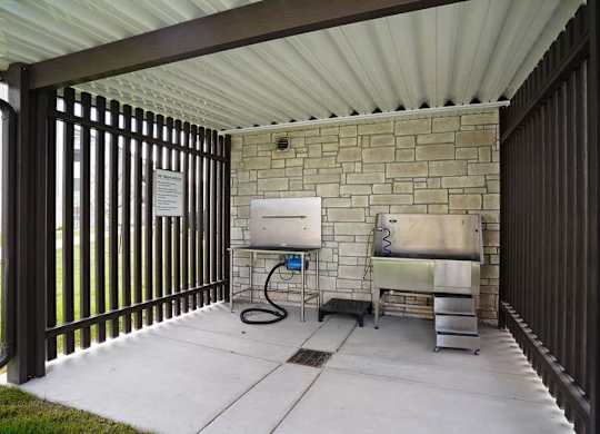 A patio with a sink and a grill.