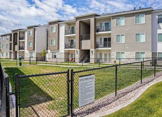 A sign in front of apartment buildings that says