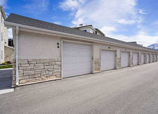 A long row of garage doors are closed.