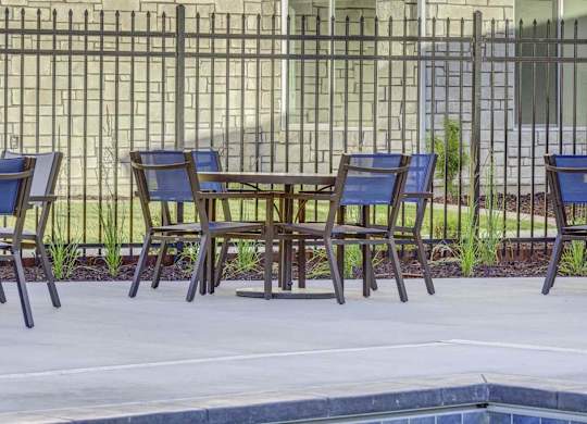 A row of chairs are lined up on a patio.