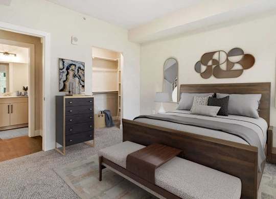 A bedroom with a large bed and a dresser.