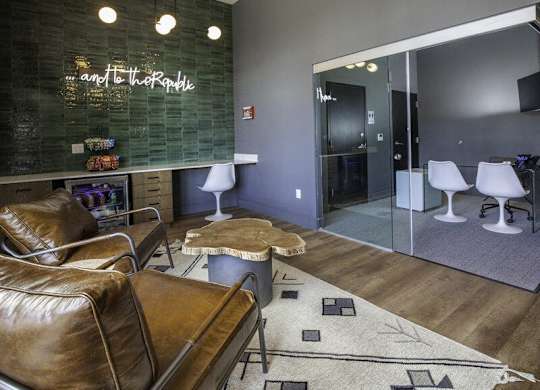 A modern living room with a brown leather chair and a glass wall.