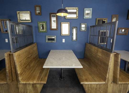 A room with blue walls and a table surrounded by chairs.