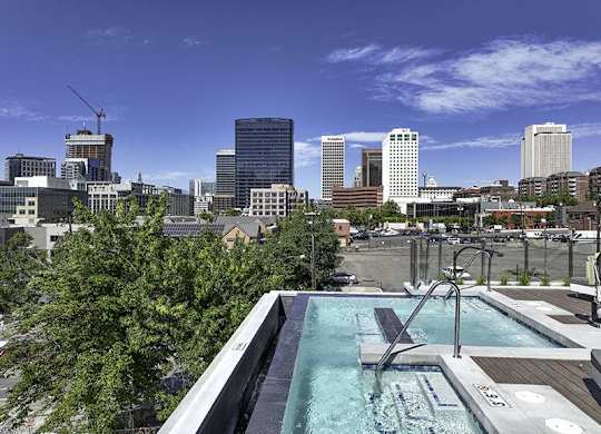 A rooftop pool with a city skyline in the background.