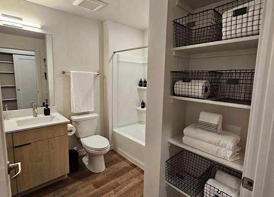 A bathroom with a toilet, sink, and bathtub.