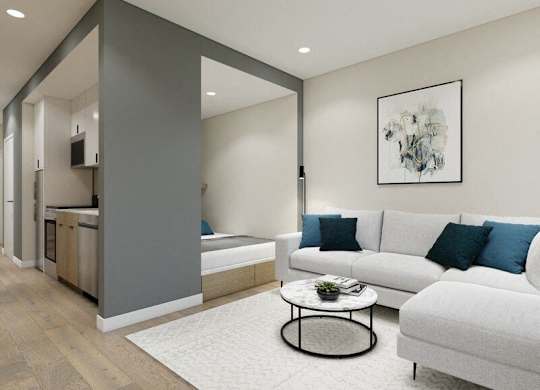 A modern living room with a grey and white color scheme.