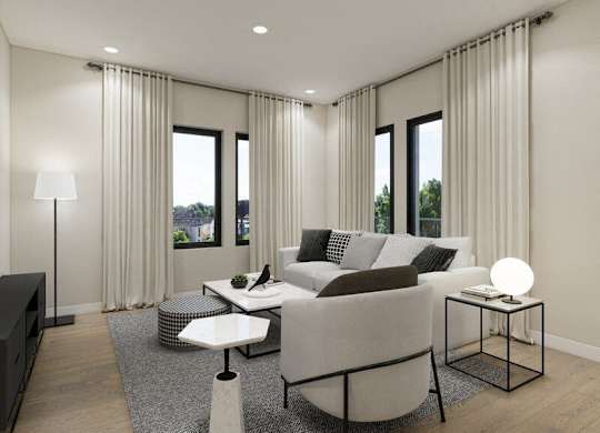 A modern living room with a grey sofa, a white coffee table, and a black floor lamp.