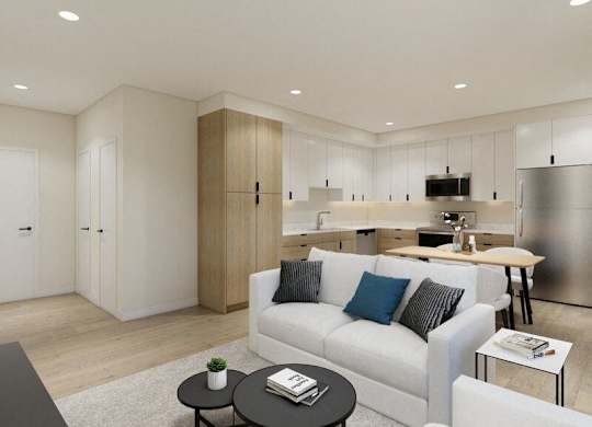 A modern living room with a white couch and a black coffee table.