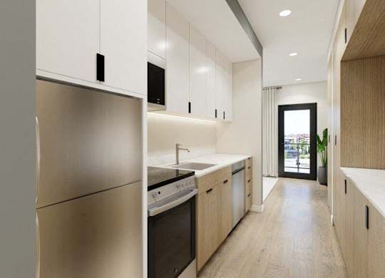 A modern kitchen with stainless steel appliances and wooden cabinets.