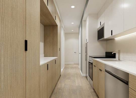 A modern kitchen with wooden cabinets and stainless steel appliances.