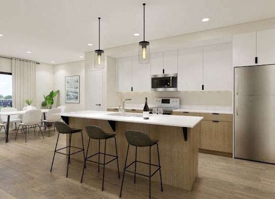 A modern kitchen with a large island and bar stools.