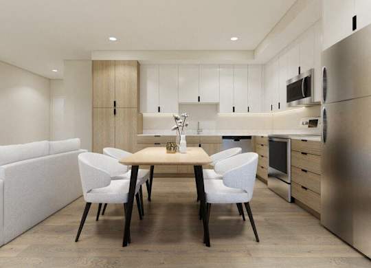 A modern kitchen with a dining table and chairs.