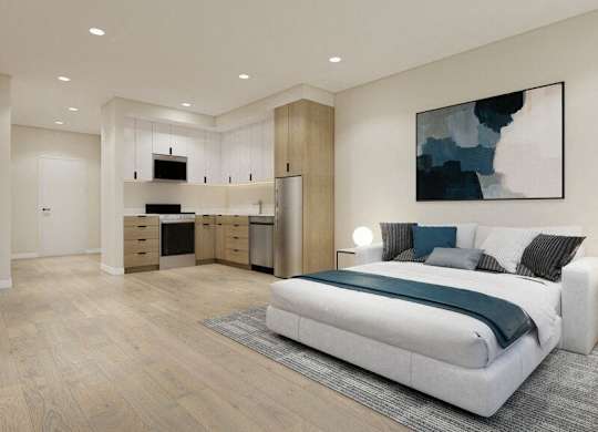 A modern bedroom with a large bed and a painting on the wall.