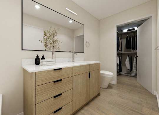 A bathroom with a vanity, mirror, and a towel.