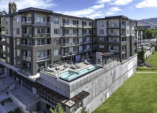 A large concrete building with a pool in the middle.
