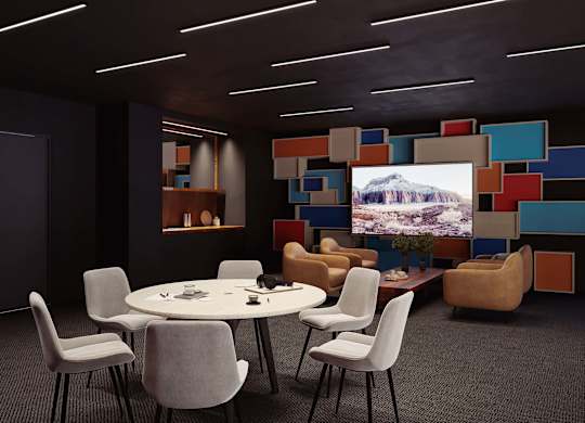 A conference room with a large screen displaying a mountain landscape.