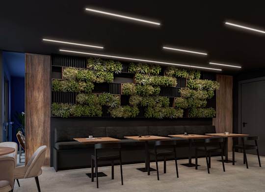 A modern dining area with a long table and chairs.